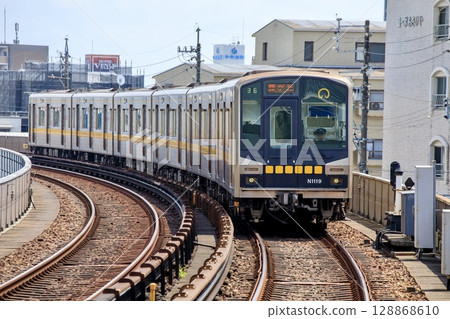 N1000 series train running near Fujigaoka Station on the Higashiyama Subway Line 128868610
