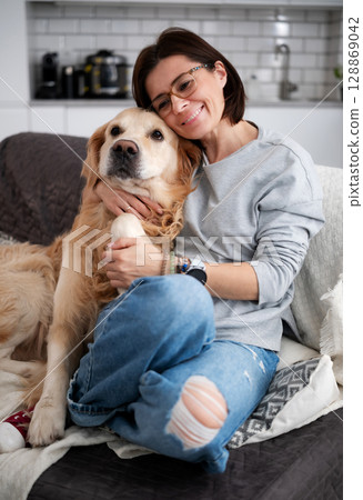 Happy Woman Hugging Adorable Dog And Relaxing At Home Happy Woman Hugging Adorable Dog And Relaxing At Home 128869042