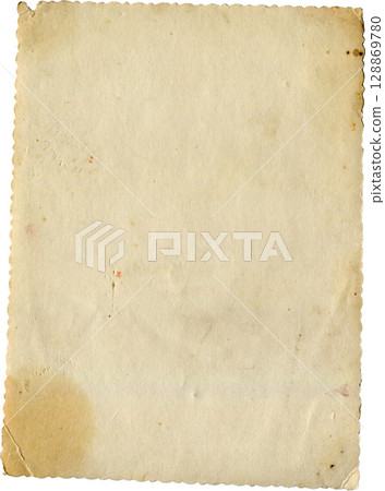 Antique paper sheet with ripped edges and vintage texture. Aged and ragged parchment look. 128869780