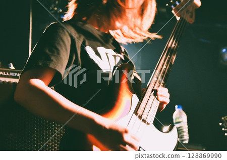A female bassist performing live A female bassist performing live 128869990