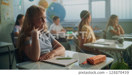 Team of Smart Diverse Kids Sitting at Desks, Studying Ecology, Listening to Lecture from Teacher 128870439