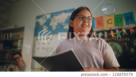 Renewable Energy Lesson: Elementary School Girl Speaking, Giving Presentation in Front of Classmates Renewable Energy Lesson: Elementary School Girl Speaking, Giving Presentation in Front of Classmates 128870579