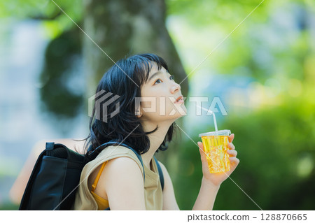 A woman walking in green 128870665