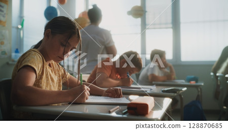 Elementary School Students Writing Exam or Doing Tasks in Notebooks 128870685