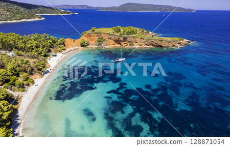 Greece travel, green picturesque Sporades. Alonissos island beast scenic beaches - Kokkinokastro aerial drone view  128871054