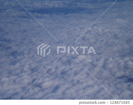 Plane is flying through a cloudy sky Plane is flying through a cloudy sky 128871085