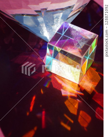 Cube is sitting on a table next to a diamond 128871092