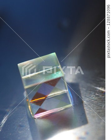 Small cube of glass with a rainbow pattern on it Small cube of glass with a rainbow pattern on it 128871096