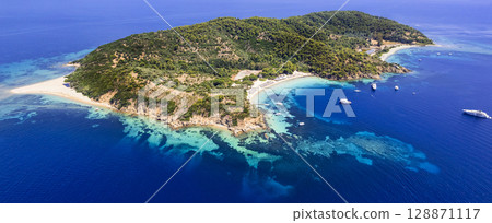 Greece, Best beautiful beach destinations of Skiathos island (Sporades) - stunning island Tsouguria with white sandy beaches . High angle drone aerial view Greece, Best beautiful beach destinations of Skiathos island (Sporades) - stunning island Tsouguria with white sandy beaches . High angle drone aerial view 128871117