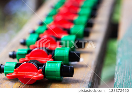 modern parts for collecting drip irrigation for plants in the country, close-up modern parts for collecting drip irrigation for plants in the country, close-up 128872460