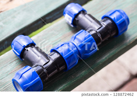 modern parts for collecting drip irrigation for plants in the country, close-up modern parts for collecting drip irrigation for plants in the country, close-up 128872462