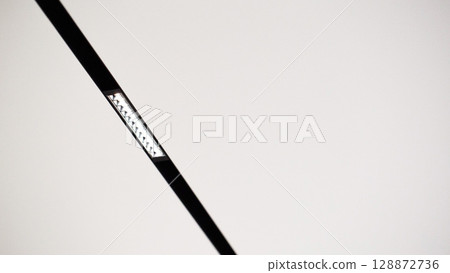 LED strip lighting on white stretch ceiling. Copy space for text LED strip lighting on white stretch ceiling. Copy space for text 128872736