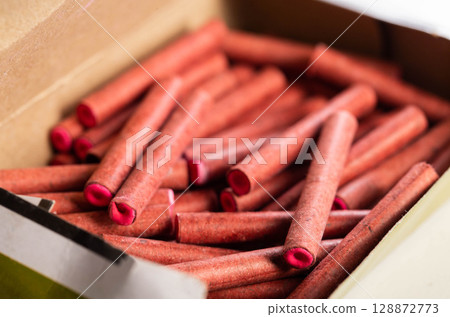 A bunch of firecrackers with red sulfur. Set of pyrotechnics, explosion hazard, macro. 128872773