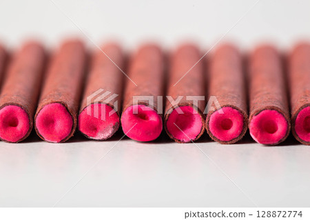 A bunch of firecrackers with red sulfur. Set of pyrotechnics, explosion hazard, macro. Copy space for text 128872774