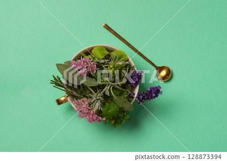 Assorted Fresh Herbs Bouquet In A Cup On Teal Background Assorted Fresh Herbs Bouquet In A Cup On Teal Background 128873394