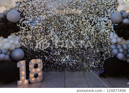Birthday celebration setup with a Happy Birthday message and illuminated 18 marquee numbers Birthday celebration setup with a Happy Birthday message and illuminated 18 marquee numbers 128873406