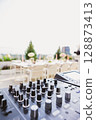Outdoor DJ setup at dusk, bathed in dynamic lights 128873413