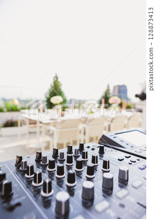 Outdoor DJ setup at dusk, bathed in dynamic lights Outdoor DJ setup at dusk, bathed in dynamic lights 128873413