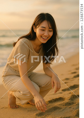 A young woman smiling at the beach at dusk, a peaceful moment 128873534