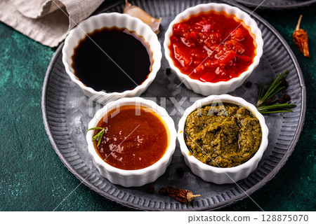 Set of different sauces. Ketchup, mustard, pesto 128875070