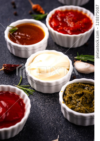Set of different sauces. Ketchup, mustard, pesto Set of different sauces. Ketchup, mustard, pesto 128875087