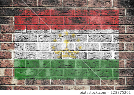 Tajikistan flag on a brick wall background 128875201