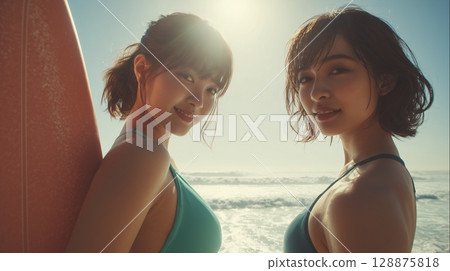 A Japanese woman walking on the beach with a surfboard 128875818