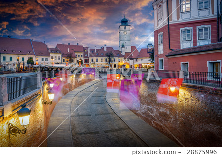 Council Tower in Sibiu at Sunset Dramatic Sky with Orange Clouds and Blue Horizon Council Tower in Sibiu at Sunset Dramatic Sky with Orange Clouds and Blue Horizon 128875996