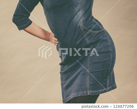 Attractive blonde woman wearing tight jeans dress Attractive blonde woman wearing tight jeans dress 128877206