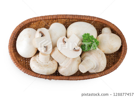 Fresh mushroom champignon in a wicker basket isolated on white background. Top view. Flat lay. Fresh mushroom champignon in a wicker basket isolated on white background. Top view. Flat lay. 128877457