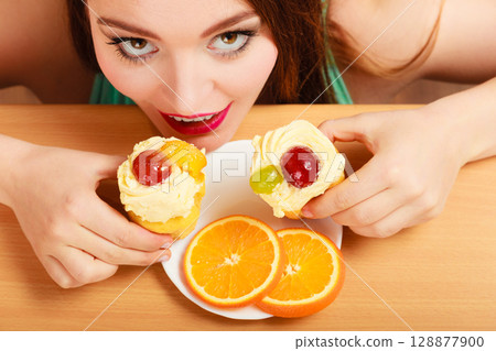 Woman taking delicious sweet cake. Gluttony. 128877900