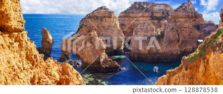 Amazing rocky scenic becahes of Algarve coast, Portugal. Breathtaking famous beach Praia da Marinha 128878538