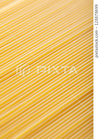Raw Spaghetti Noodles in Diagonal Food Background Macro Shot Raw Spaghetti Noodles in Diagonal Food Background Macro Shot 128878699