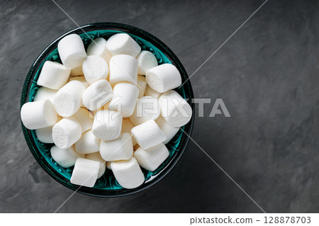 White Marshmallow Candies in Bowl on Dark Gray Background Top View Copy Space White Marshmallow Candies in Bowl on Dark Gray Background Top View Copy Space 128878703