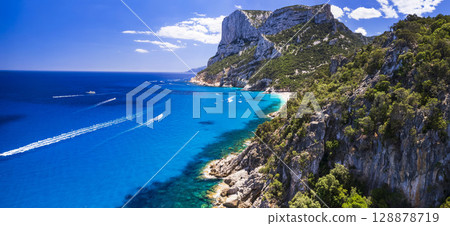Best and most beautiful beaches of Sardegna island (Italy) - impressive Cala Sisine in gulf of Orosei . Aerial panoramic drone view  128878719