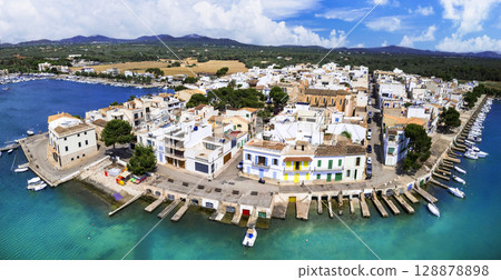 Mallorca island landmarks. Scenic fishing village Portocolom with colorful houses and boats . Popular tourist destination. Balears, Spain. Mallorca island landmarks. Scenic fishing village Portocolom with colorful houses and boats . Popular tourist destination. Balears, Spain. 128878898