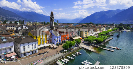 Switzerland travel and landmarks - colorful charming town Ascona, lake Lago Maggiore near Locarno , canton Ticino . aerial drone panoramic view of old town Switzerland travel and landmarks - colorful charming town Ascona, lake Lago Maggiore near Locarno , canton Ticino . aerial drone panoramic view of old town 128878899