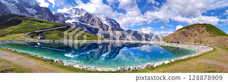 Switzerland nature . panoramic view of Fallboden lake with turquoise water and reflections of snowy peaks. Kleine Scheidegg mountain pass famous for hiking in Bernese Alps. Swiss travel Switzerland nature . panoramic view of Fallboden lake with turquoise water and reflections of snowy peaks. Kleine Scheidegg mountain pass famous for hiking in Bernese Alps. Swiss travel 128878909