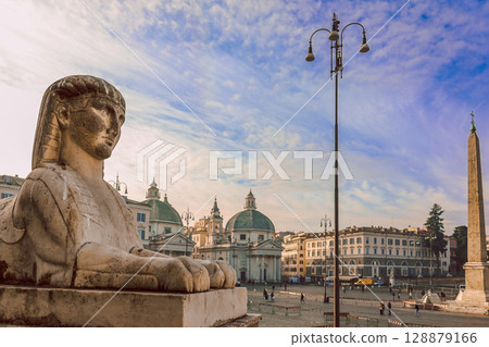 Sphinx statue in Piazza del Popolo square, Rome, Italy. In background twin churches, selective focus. High quality photo 128879166
