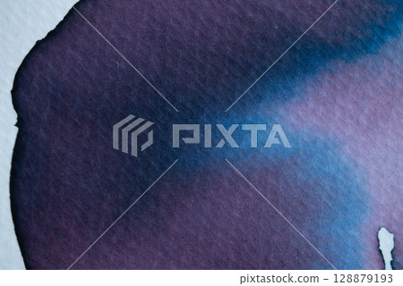 Beautiful blend of blue and purple ink creating a vibrant abstract design on textured paper Beautiful blend of blue and purple ink creating a vibrant abstract design on textured paper 128879193