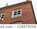 Ornate Stone Details on a Red Brick Building Corner 128879208