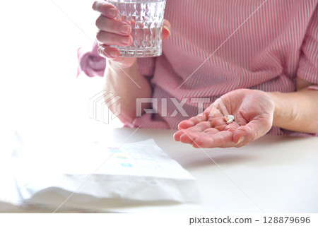 Seniors taking oral medication Seniors taking oral medication 128879696