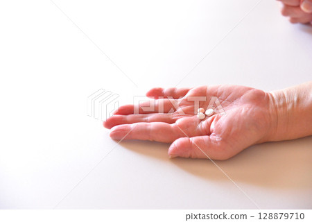 Seniors taking oral medication 128879710