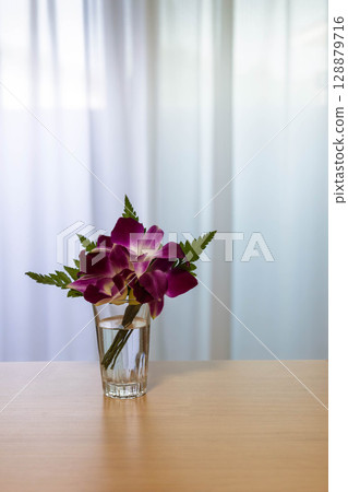 Fresh flower corsage in a glass Fresh flower corsage in a glass 128879716