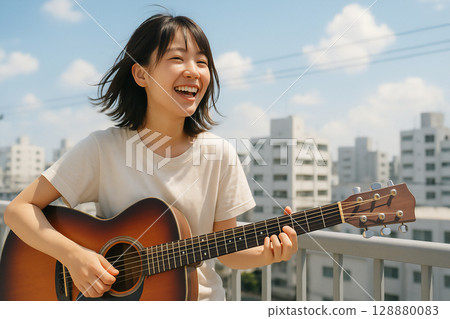 A woman playing the guitar 128880083
