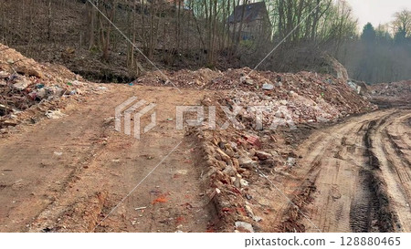 Urban Landscape Featuring Construction Debris, Dirt Path, and Ongoing Development Activity Urban Landscape Featuring Construction Debris, Dirt Path, and Ongoing Development Activity 128880465