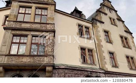 Charming Historic Building featuring Ornate Windows and an Exquisite Design that Captivates Charming Historic Building featuring Ornate Windows and an Exquisite Design that Captivates 128880476