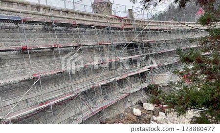 Scaffolding is used on a bridge undergoing significant renovation and repair work Scaffolding is used on a bridge undergoing significant renovation and repair work 128880477