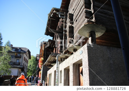 The rat-guard structure seen in the traditional architecture of Zermatt, Switzerland 128881726