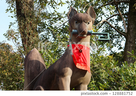Guardian fox statue at Inari Shrine (a fox holding a key) 128881752